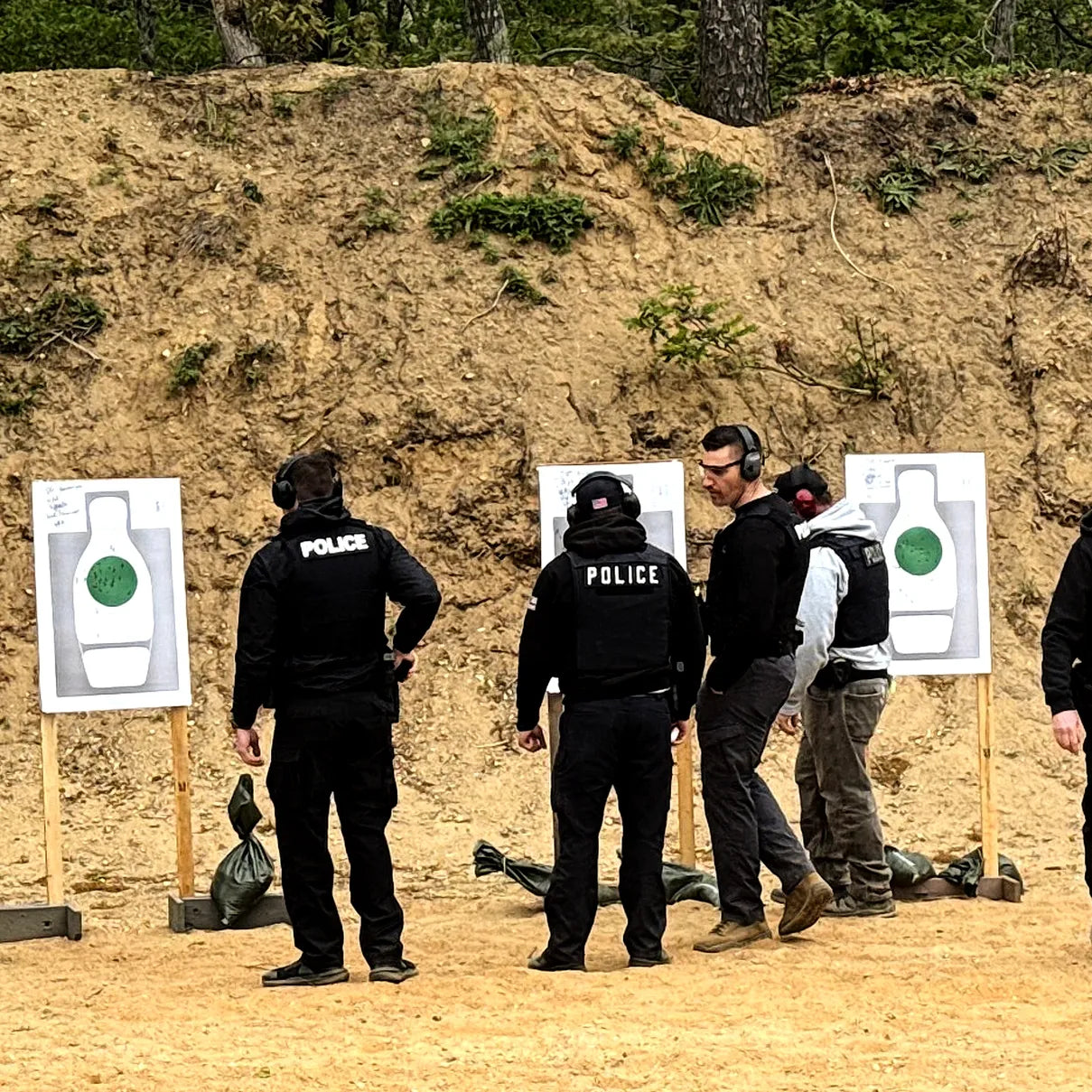 Police officers receiving practical firearms instruction on the range